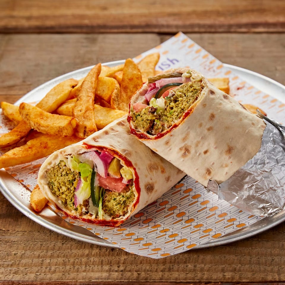 Two Manakish falafel wraps with fresh vegetables and fries on a metal plate.
